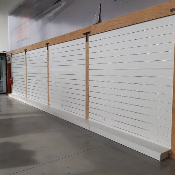 White 150mm slatwall panel wall with wooden accents in a modern interior setting
