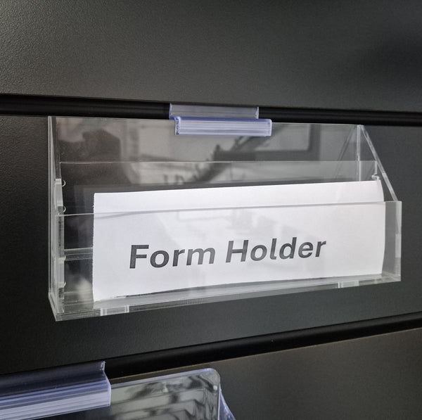 Clear form holder labeled 'Form Holder' attached to a black slatwall