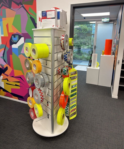 freestanding rotating three-sided slatwall tower with double prong hook with loop fronts and single prond hooks  