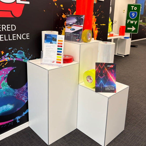 Exhibition display cube stand from Orfol booth with colorful design and text in a room setting with brochure holders