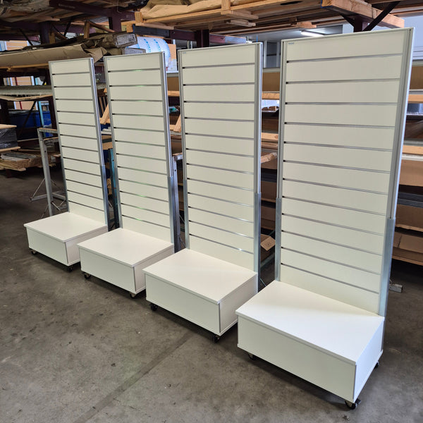 A row of Plankwall Light free standing display panels in white in the factory