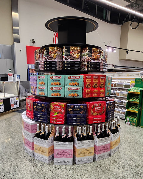 5 tier retail display stand of snacks on circular shelves in a store