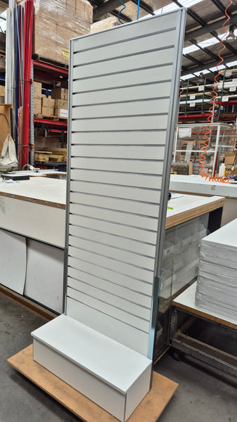 Plankwall free standing wall display panel - extra tall and white - in a factory setting 