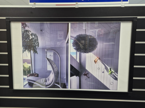 A large black snap poster frame with photos of a house interior hanging on black slatwall