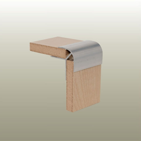 Close up of a Stickman sample of a C09 aluminium corner profile joining two 9mm non mitred light wood MDF panels on a gold background