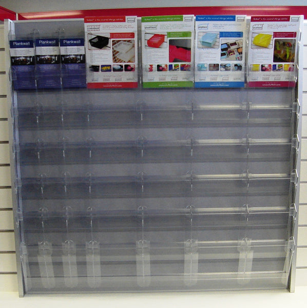 Calext Clear plastic modular brochure display rack with promotional brochures wall-mounted on a PLankwall panel.