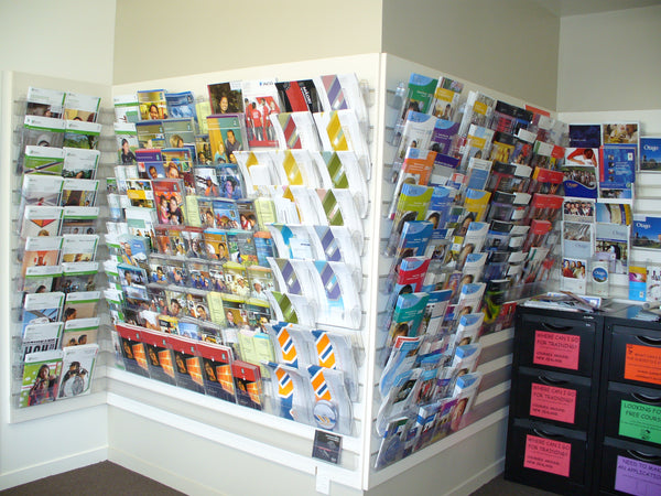 Calext wall-mounted modular clear brochure display rack displaying various brochures and leaflets mounted on Plankwall panels in a school careers centre. 