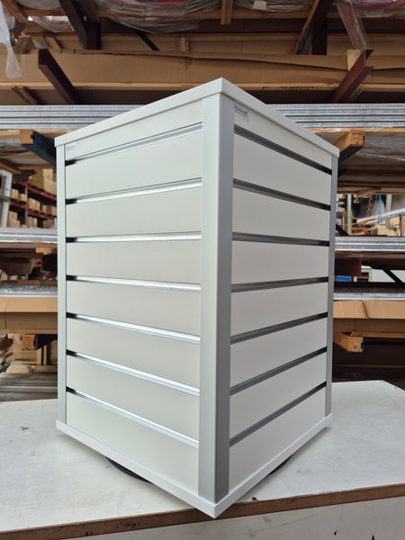 white rotating countertop slatwall retail display stand in a factory setting