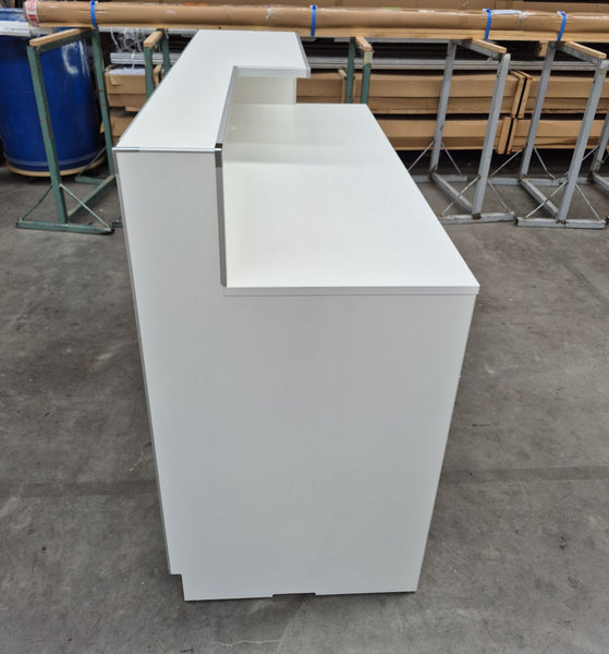 White customised lockable cashier reception desk in a warehouse setting