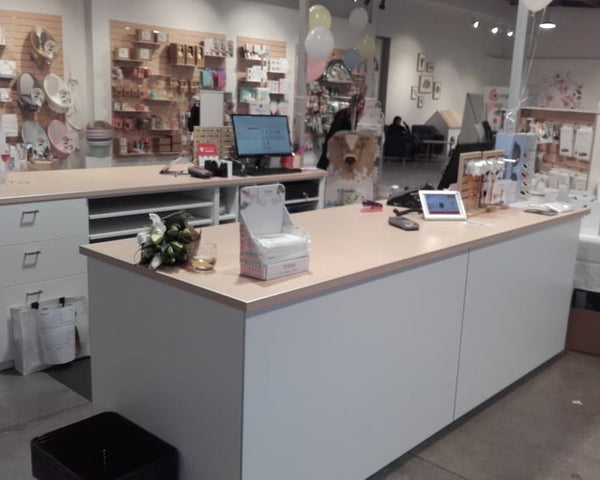 Store retail counter with computer and decor in a retail setting