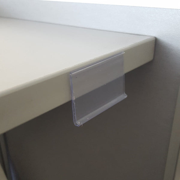 Flat clear ticket strip with a self-adhesive back tape, with a visible yellow border.