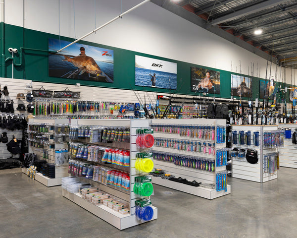 Hunting & Fishing shop fitout using Plankwall Washed Oak slatwall gondolas for floor stock and slatwall panels displaying various fishing products and merchandise.
