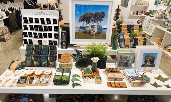 Large Plankwall white nesting display tables used in a front retail window displaying high end art and tourist souvenirs.