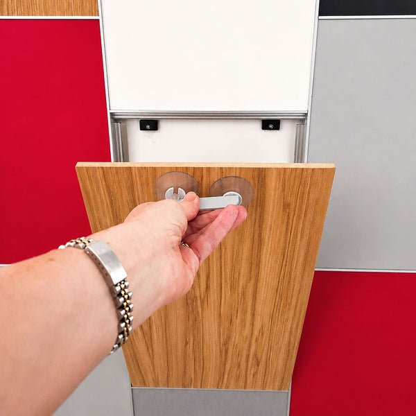 photo of a concealed panel formed in a multi coloured panel work using MCLNWFJOIN Stickman Linear Wall Fix butt join profiles shown being opened by a hand holding a magnet 