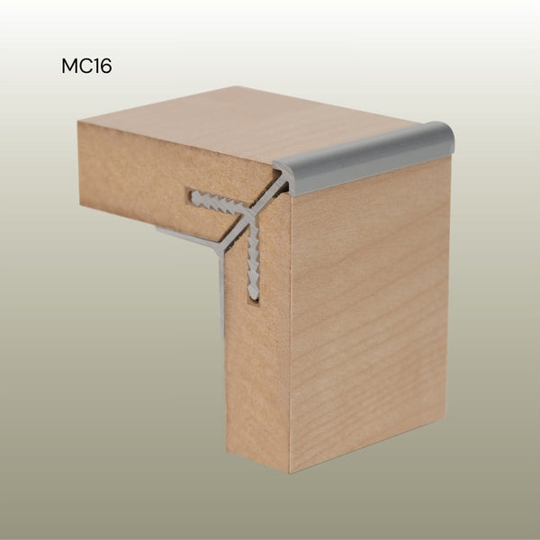 Photo of a MC16 round head aluminium external corner join in MDF panels in cluse up on a gold background