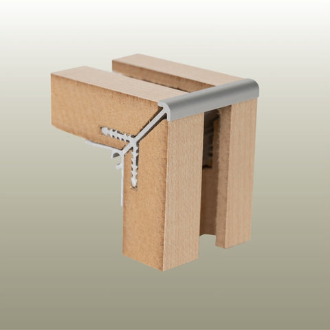 A close-up of a MC18X external corner join joining  MDF slatwall panels shown on a neutral gradient background.