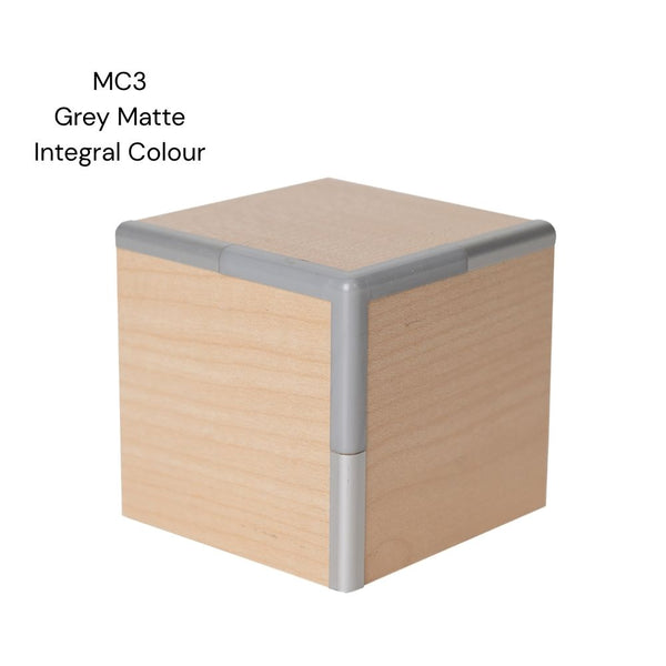 A MC3 round head 3 way corner join sample shown in integral colour aluminium joining light wood MDF panels on a white background labelled MC3 grey matte integral colour.