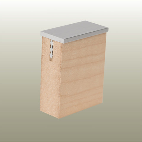 Close up of a Stickman aluminium MCLNCAP capping profile section inserted in a 18 mm MDF panel on a gold background