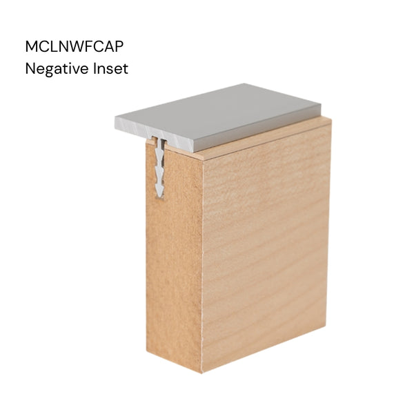 Close up of a Stickman aluminium MCLNWFCAP wall fix capping profile negative inset section inserted in a 18 mm MDF panel on a white background labelled