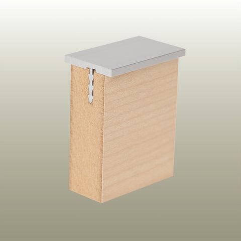 Close up of a Stickman aluminium MCLNWFCAP wall fix capping profile section inserted in a 18 mm MDF panel on a gold background