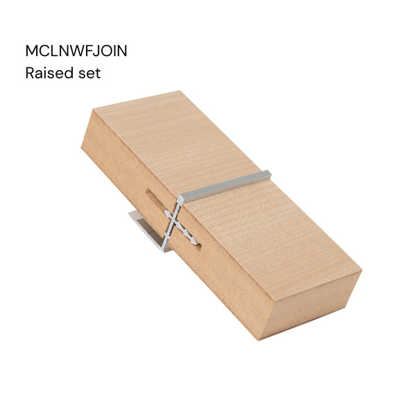 a close up of a Stickman Linear MCLNWFJOIN sample - a aluminium butt join profile in raised set with wall fix in MDF panels on a white background labelled with the product name
