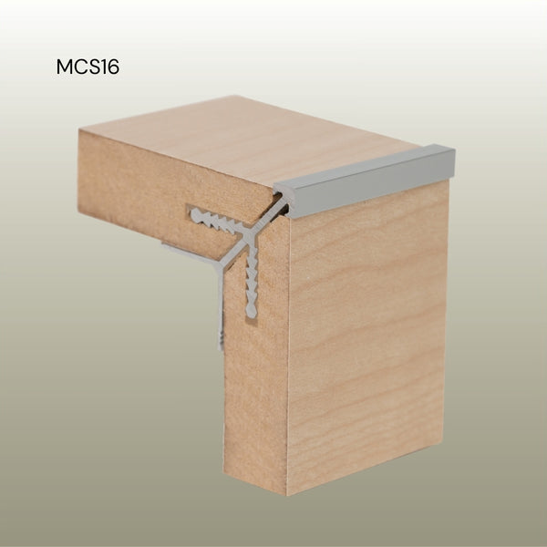 Photo of a MCS16 square round head aluminium external corner join in MDF panels in cluse up on a gold background