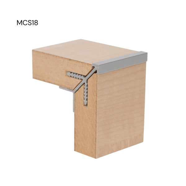 close up of a Stickman sample of a MCS18 square head aluminium corner profile joining two light wood MDF panels on a white background labelled MCS18