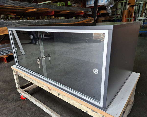  Made with Plankwall door tracks this  lockable glass sliding door cabinet is custom made in black MDF 