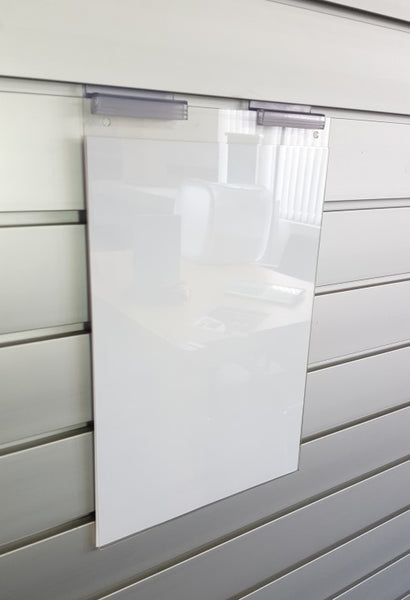 A clear leaflet display holder wall mounted on a slatwall panel using Plankwal supergrip clip