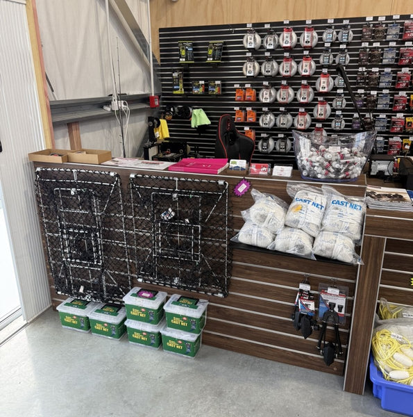 Display of fishing gear and tackle products featured on a retail counter unit and slatwall specially designed by the retailer and the team at Plankwall