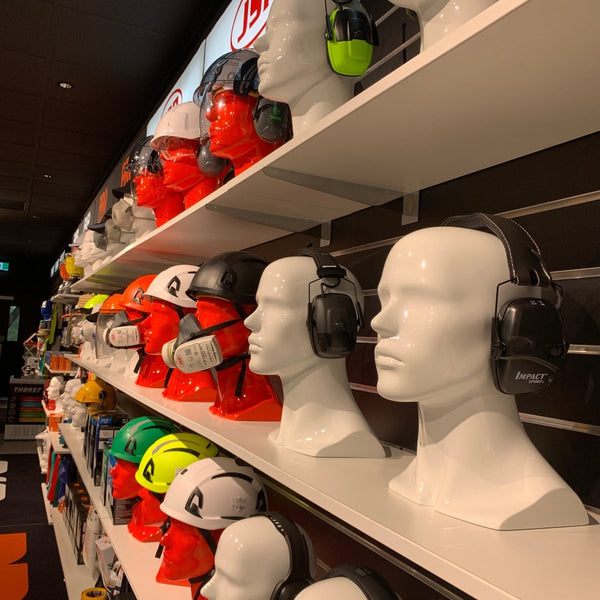 Metal shelf bracket shown here on the underside of various helmets on mannequin heads with a brand logo in the background.