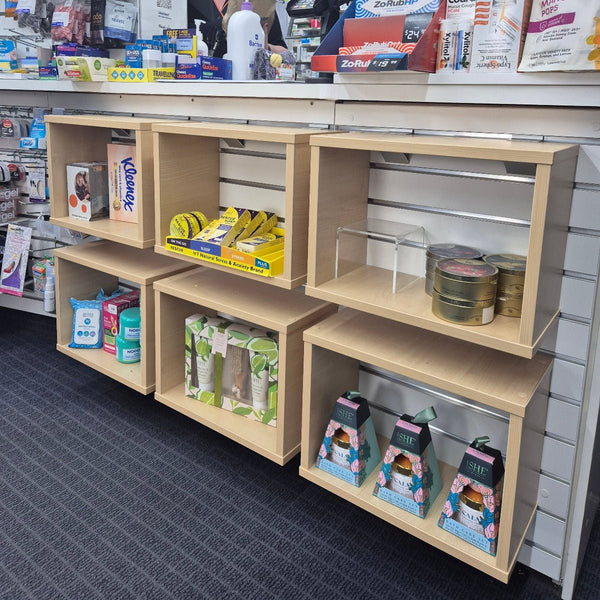 Slatwall mounted open display boxes from Plankwall shown here at Unichem Howick Pharmacy 