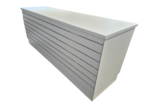 The front of a Plankwall retail counter with slatwall for product displays in white on a white background