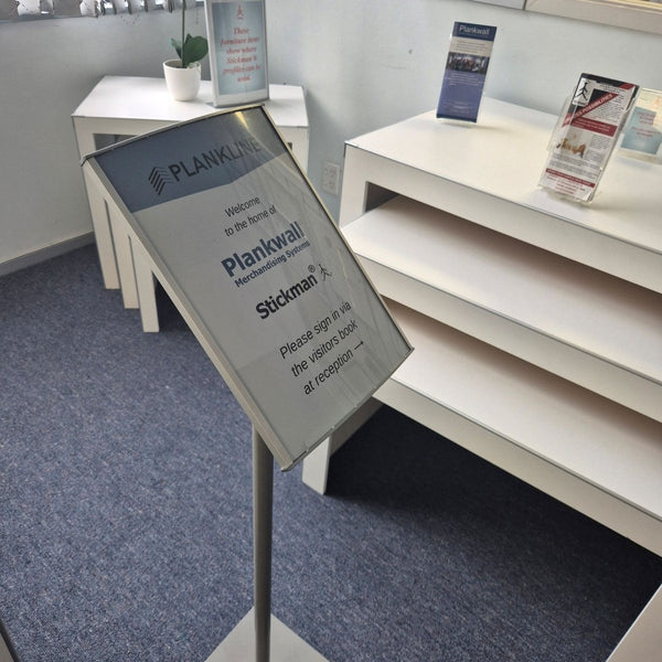 close up of the plankwall radius floorstand  sign holder in showroom 