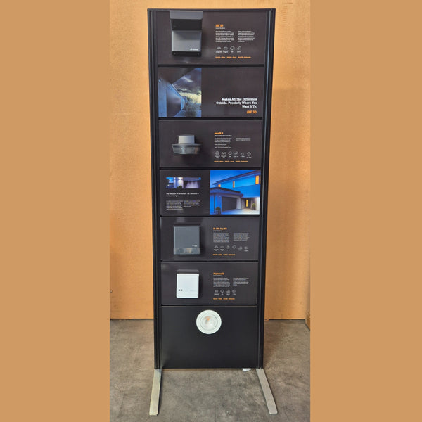 Two-sided slatwall display panel in all black used to display lighting samples and information - free standing on metal feet
