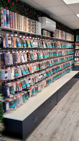 Phone store interior with shelves stocked with products on Plankwall black 100mm slatwall panels and a tiled floor.