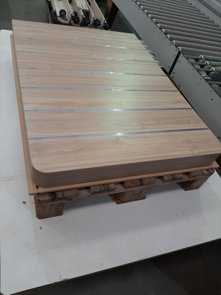 Wooden pallet stacked with Plankwall 150mm slatwall panels in woodgrain in the factory