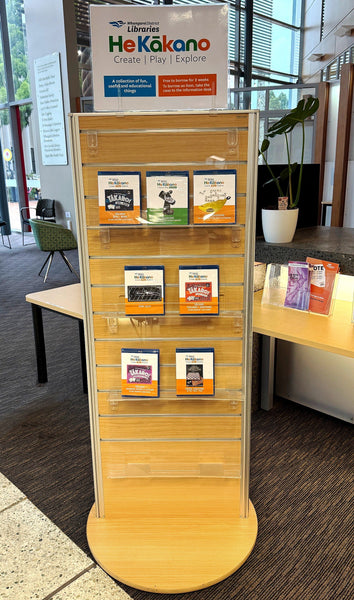 Plankwall two-sided rotating display stand in Tawa woodgrain displaying pamphlets
