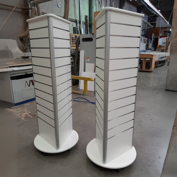 Plankwall 3 sided triangular free standing displays x2 in white on  factory floor shot from straight angle