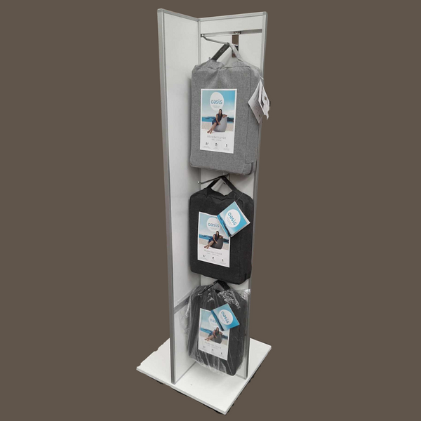 A tall , narrow Plankwall freestanding four-sided display unit with slatwall panels on all sides displaying bean bags on hooks on a cutout background