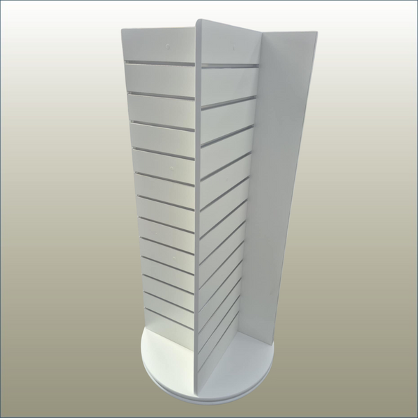 A white, free-standing four-sided display unit with slatwall panels on all sides, equipped with castor wheels for mobility.