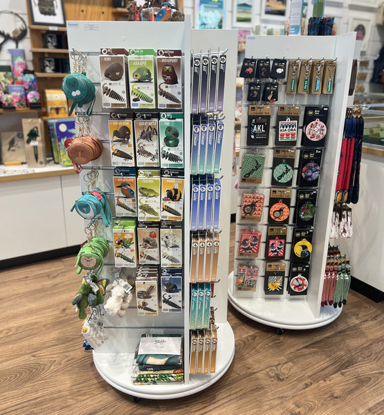 2x Plankwall freestanding four-sided display unit with slatwall panels on all sides displaying retail items in a store