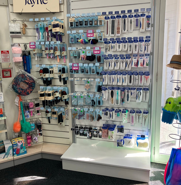 Plankwall Free Standing white slatwall free standing display walls. Code FS2212PW using G18PB. With plinth, 50mm aluminium pitch stocked with fishing gear in pharmacy