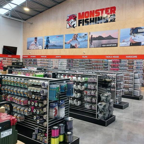 Plankwall shop fitout using Plankwall Double Plinth G60 Gondolas in black and black 50mm slatwall wall panels shown stocked with merchandise in the Monster Fishing retail showroom