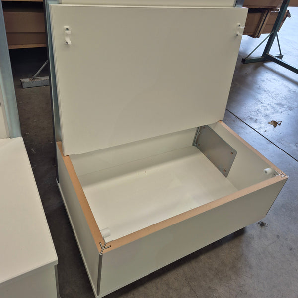 Detail of the plinth base of a Plankwall Light free standing display panel in white showing storage space