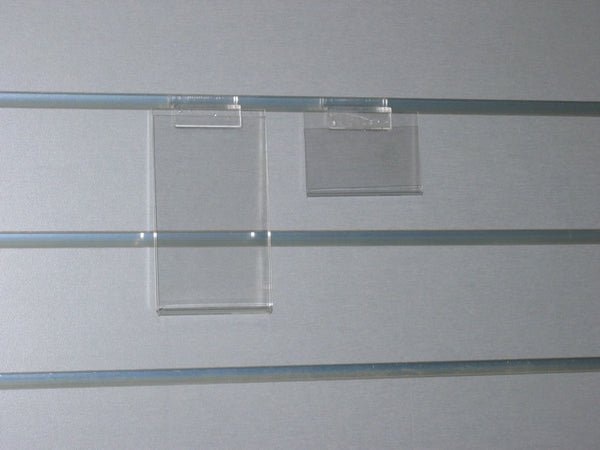 small clear acrylic display stands wall mounted on a grey slatwall panel. 