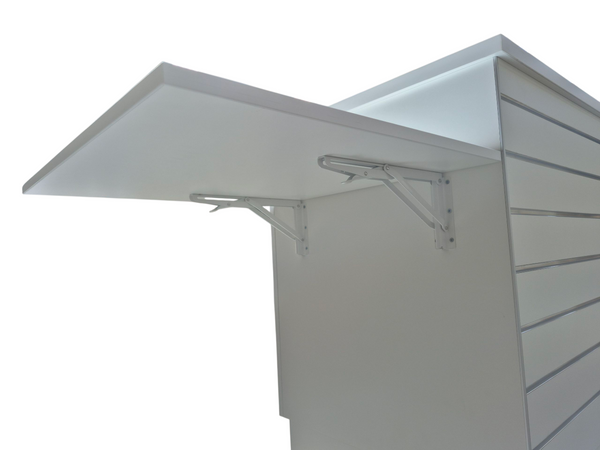Close up of a fold down shelf attached to the front of a Plankwall Retail Counter in white with slatwall hanging display space on a white background