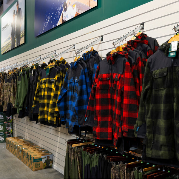 Row of Plankwall Retail Garment  Display Waterfall Brackets - 12 prongs mounted onPlankwall Slatwall with Jackets