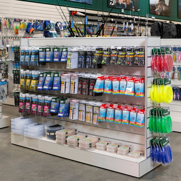 Side view of a Plankwall Retail Display Free-Standing Gondola in blonde wood finish with Display of fishing tackles and accessories in a store setting