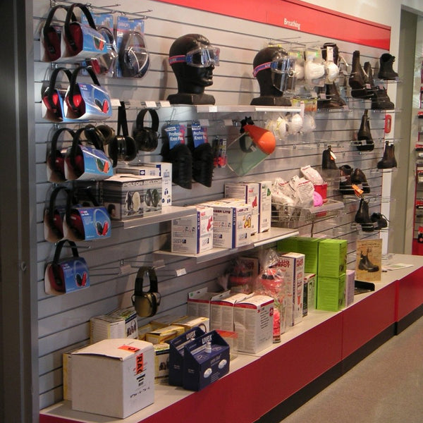 Display of safety equipment including headsets and boxes on a red and gray 100mm slatwall wall.
